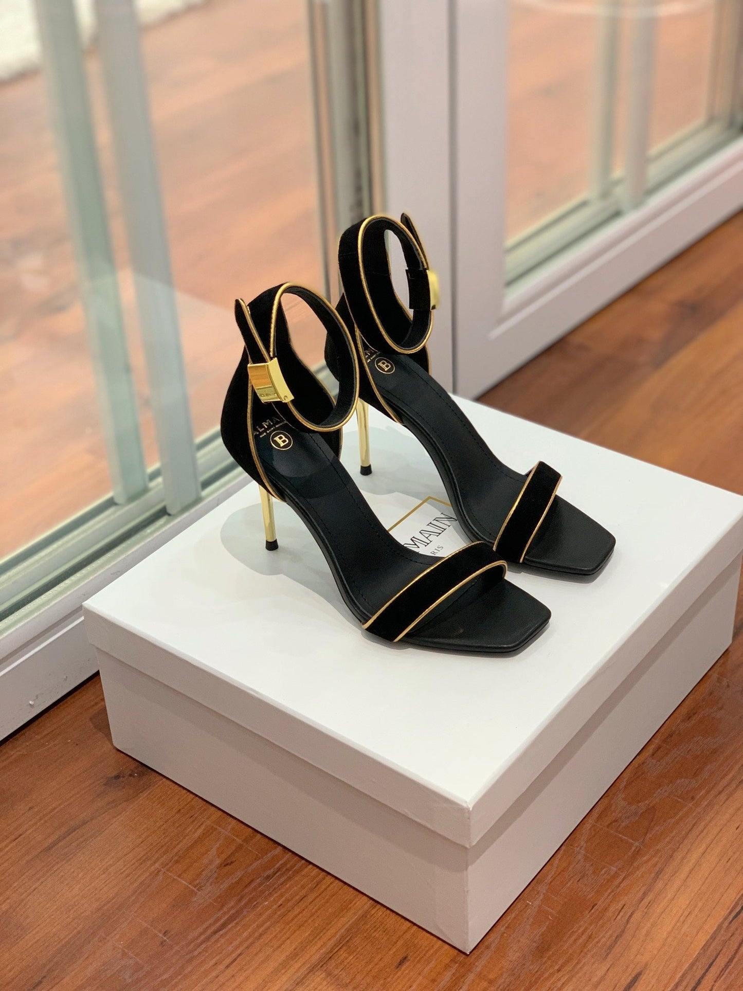 BALMAIN 25S UMA HEELED SANDALS 105MM IN BLACK SUEDE GOLD HARDWARE