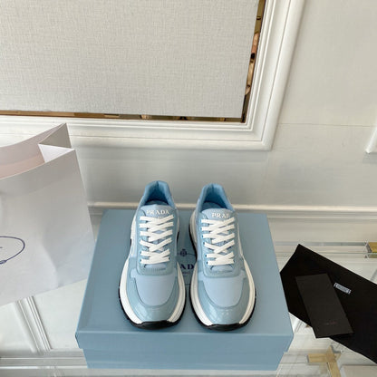 PRADA 25S THICK SOLE SNEAKER IN LIGHT BLUE CALFSKIN AND CANVAS