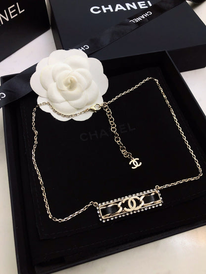 CHANEL 26S CHANEL CC LOGO CRYSTAL TRIM BAR PENDANT NECKLACE WITH BLACK LEATHER IN GOLD METAL 633315