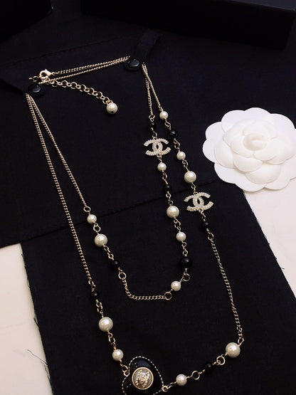 CHANEL 26S DOUBLE C LOGO BLACK & WHITE PEARL BEADED LONG NECKLACE WITH HEART CHARM IN SILVER METAL 631832