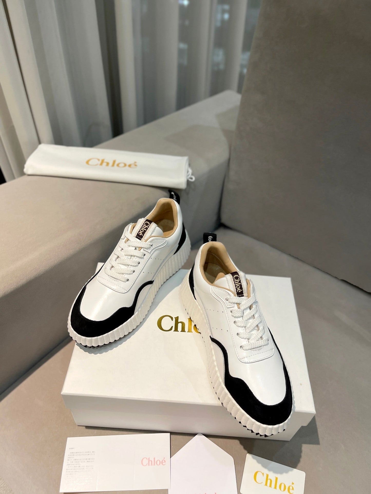 CHLOÉ NAMA SNEAKER IN WHITE LAMBSKIN AND BLACK SUEDE