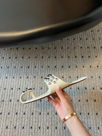ALAIA FOLDED FLAT MULES WITH SPHERES ON WHITE CALFSKIN