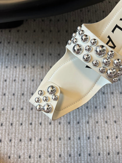 ALAIA FOLDED FLAT MULES WITH SPHERES ON WHITE CALFSKIN