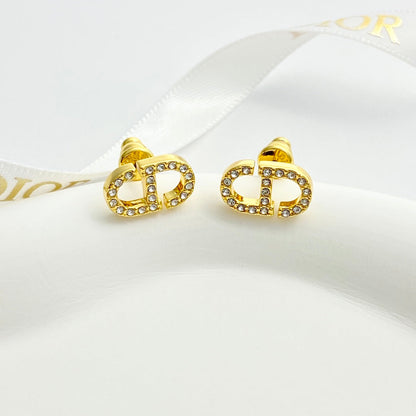 CD 26S CRYSTAL LOGO STUD EARRINGS IN GOLD METAL 633106