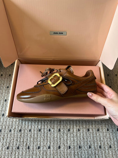 MIUMIU 26S GYMNASIUM SNEAKER IN COGNAC BROWN CALFSKIN WITH GOLD BUCKLED STRAP
