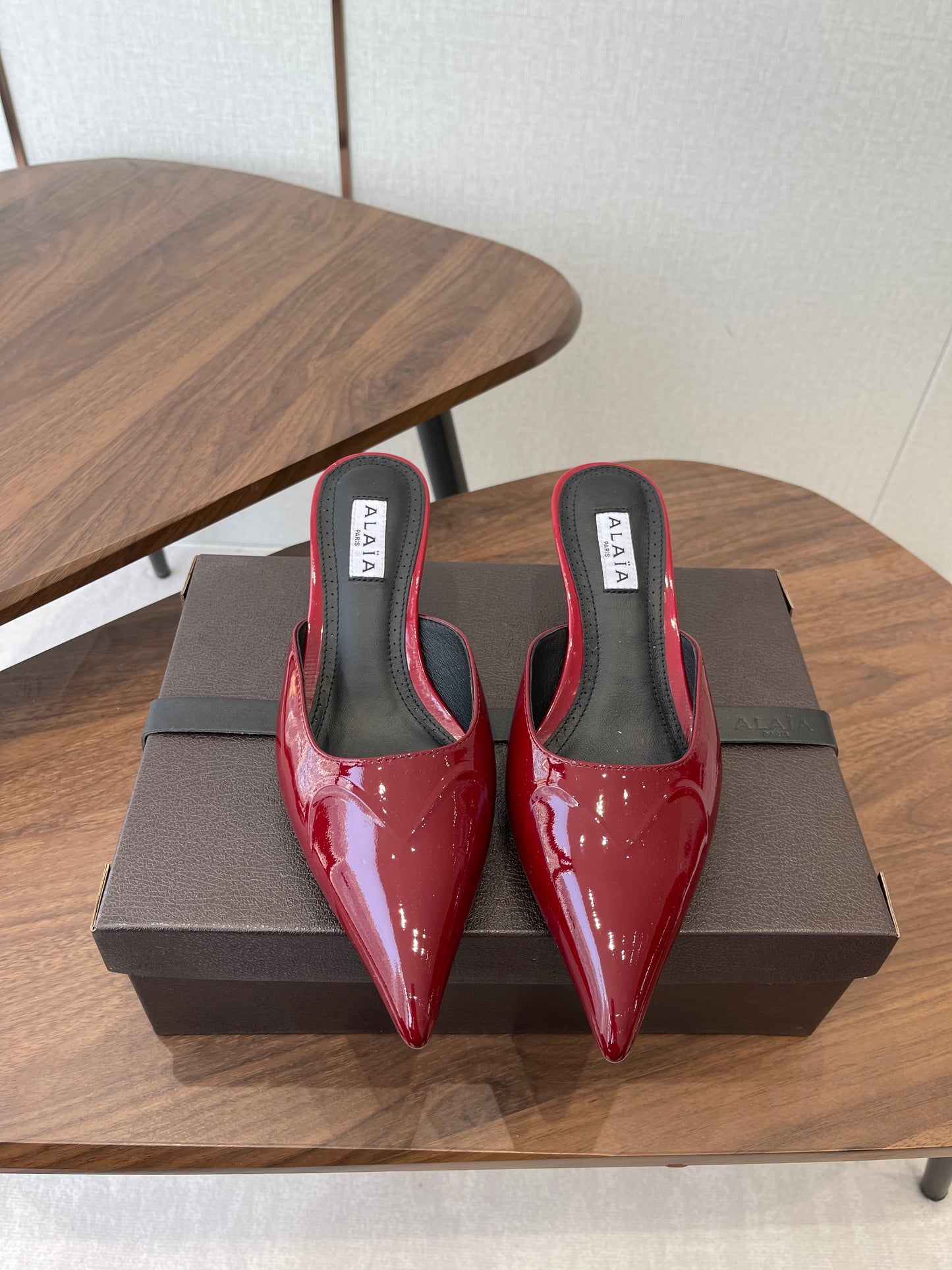ALAIA 26S HEELED MULES 50 MM IN DARK RED GLOSSY CALFSKIN