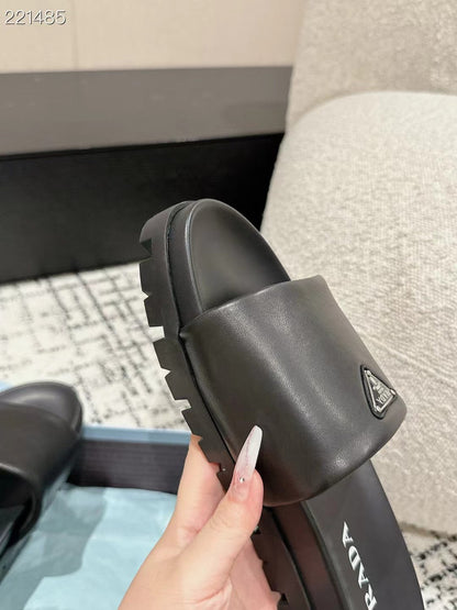 PRADA 25S PADDED SLIDES IN BLACK CALFSKIN WITH LOGO