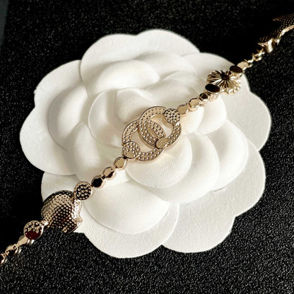 CHANEL 26S DOUBLE C LOGO CRYSTAL MULTI-CHARM STATEMENT BRACELET IN GOLD METAL 629170