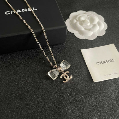 CHANEL 26S DOUBLE C LOGO CLEAR BOW PENDANT NECKLACE IN GOLD METAL 629174