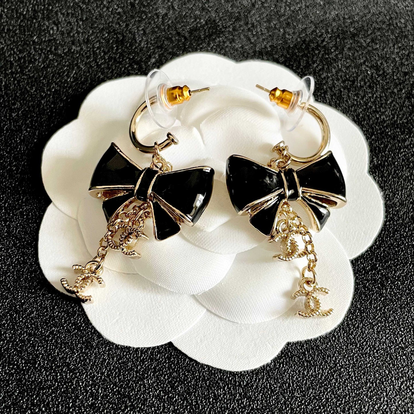 CHANEL 26S DOUBLE C LOGO BLACK ENAMEL BOW DANGLE EARRINGS WITH CHAIN CHARMS IN GOLD METAL 629178