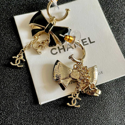 CHANEL 26S DOUBLE C LOGO BLACK ENAMEL BOW DANGLE EARRINGS WITH CHAIN CHARMS IN GOLD METAL 629178