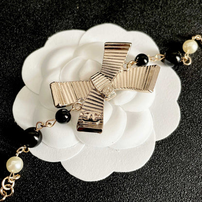 CHANEL 26S CRYSTAL BOW PEARL & BEAD CHAIN BRACELET IN GOLD METAL 629979