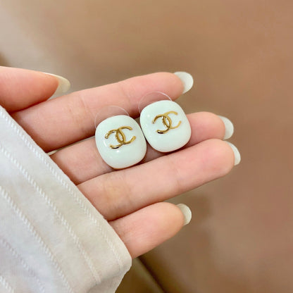 CHANEL 26S DOUBLE C LOGO WHITE ENAMEL OVAL STUD EARRINGS IN GOLD METAL 630078