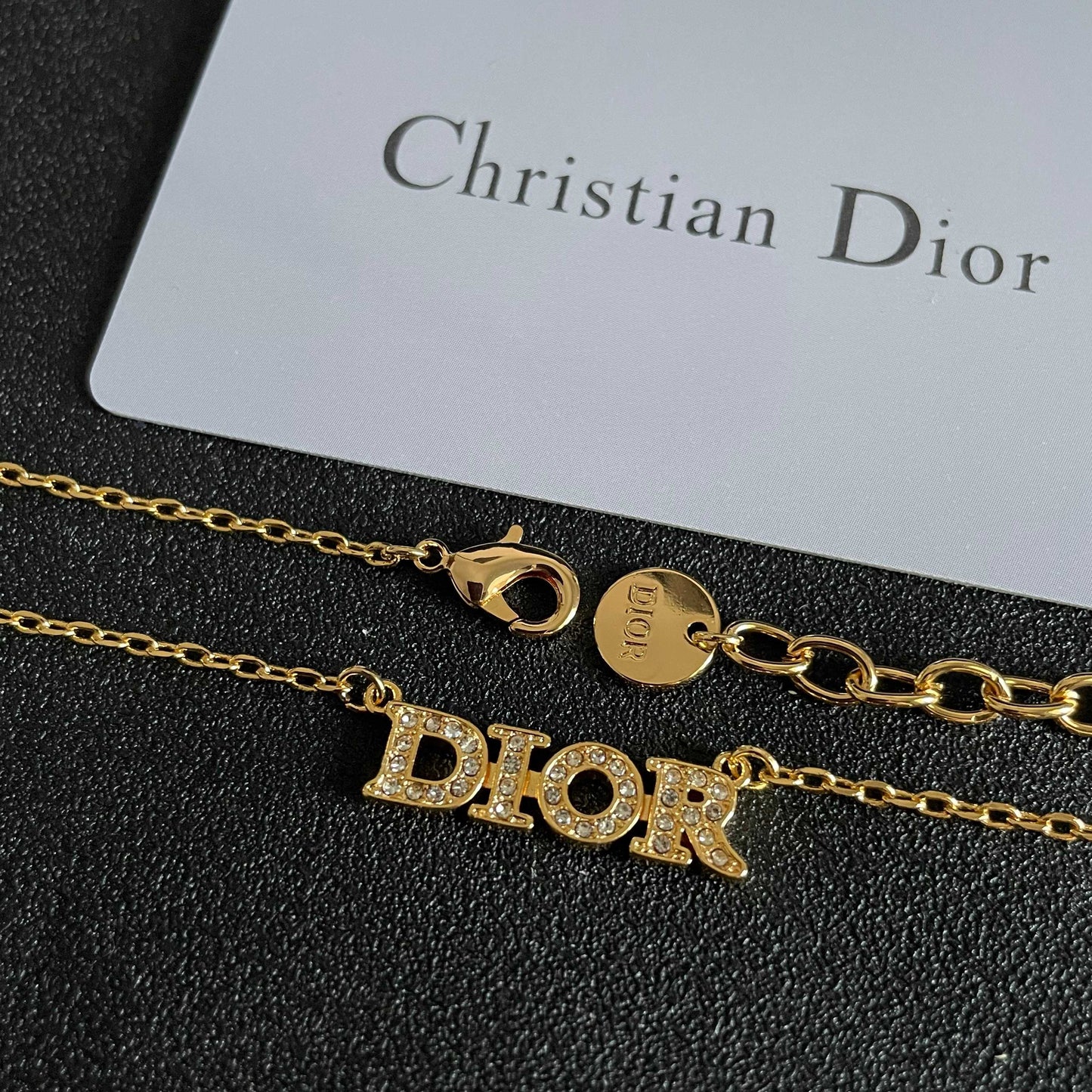 CD 26S PAVE LOGO LETTER NECKLACE IN GOLD TONE METAL 631806