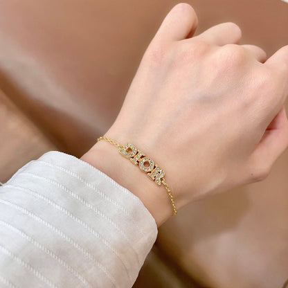 CD 26S PAVE LOGO LETTER BRACELET IN GOLD TONE METAL 631808