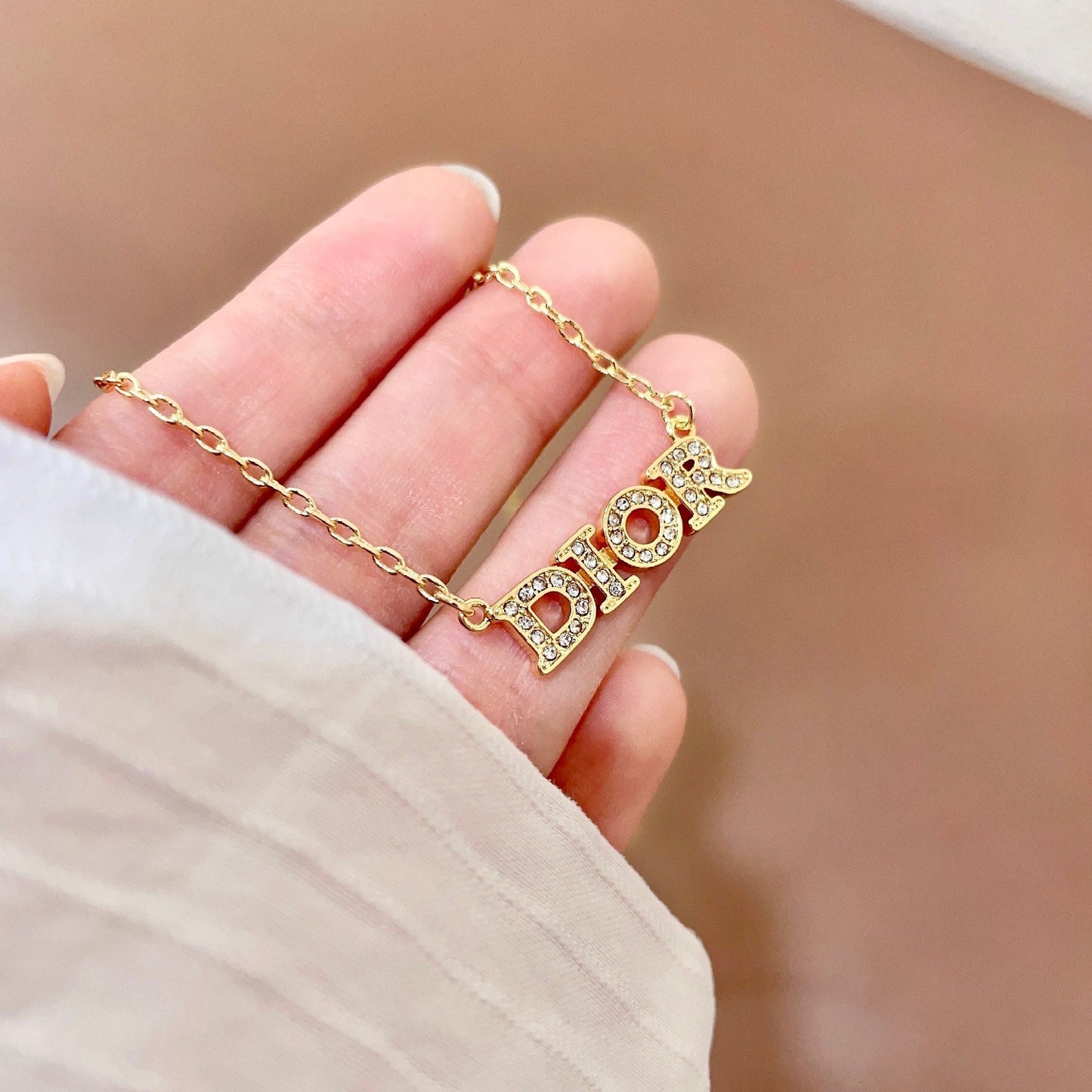 CD 26S PAVE LOGO LETTER BRACELET IN GOLD TONE METAL 631808