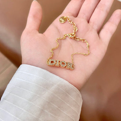CD 26S PAVE LOGO LETTER BRACELET IN GOLD TONE METAL 631808