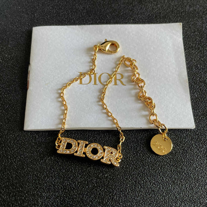 CD 26S PAVE LOGO LETTER BRACELET IN GOLD TONE METAL 631808