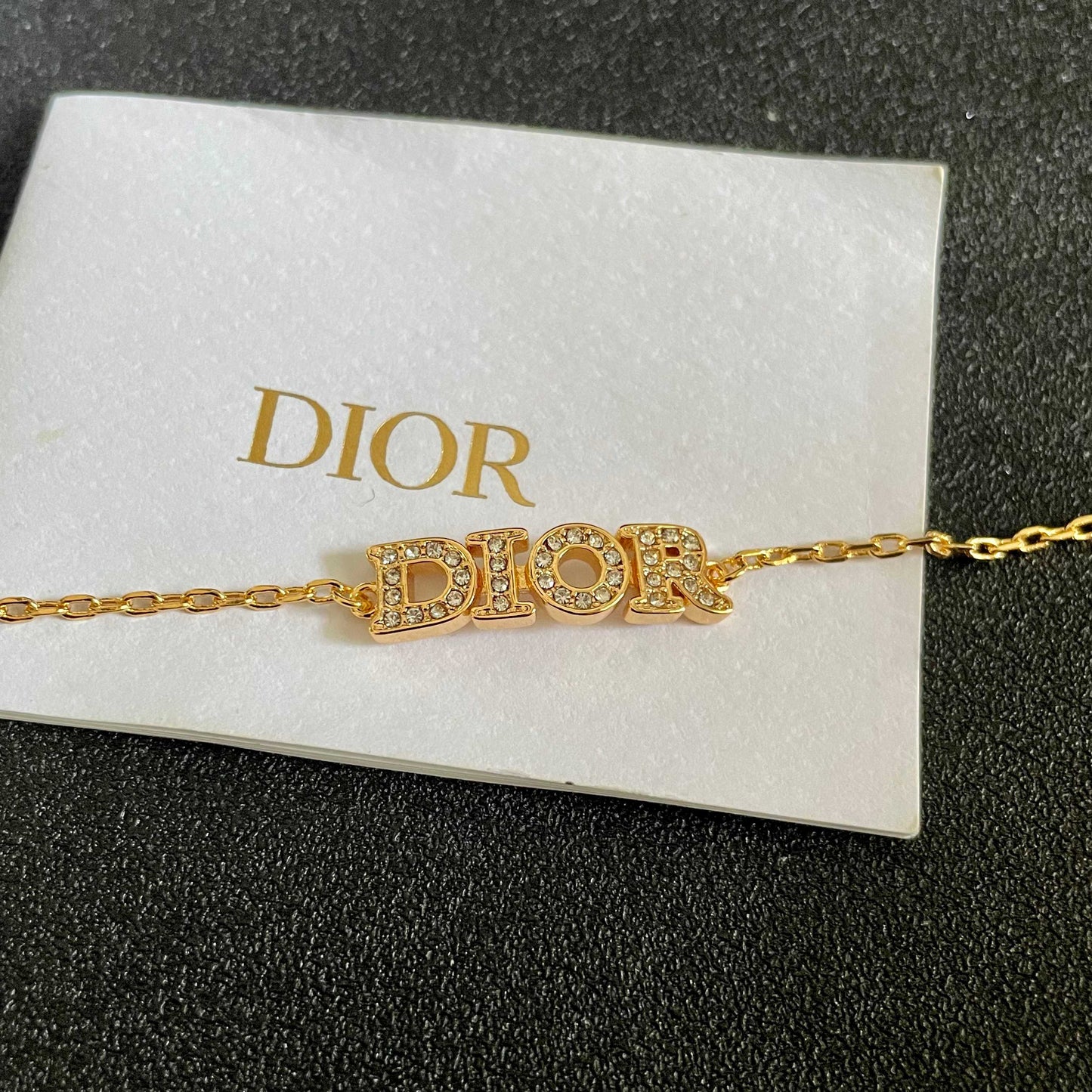 CD 26S PAVE LOGO LETTER BRACELET IN GOLD TONE METAL 631808