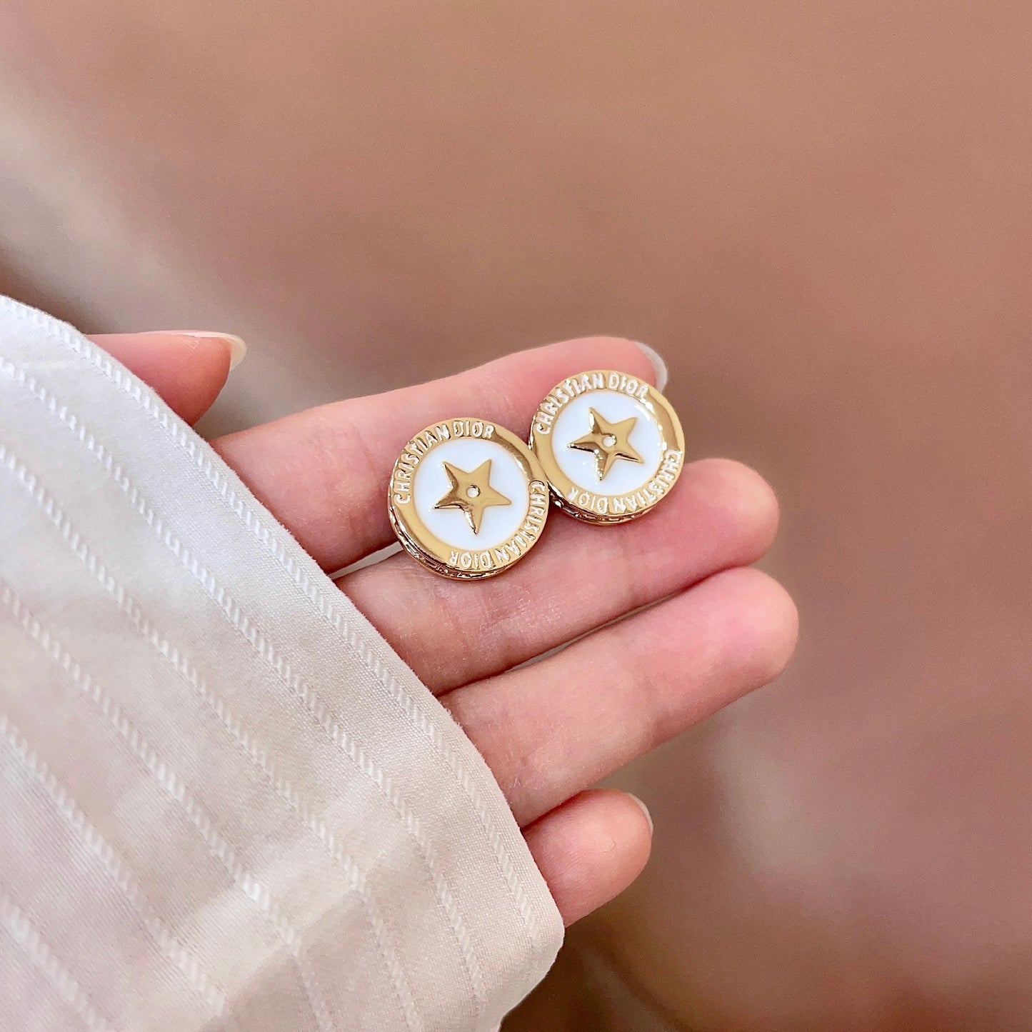 CD 26S STAR MEDALLION LOGO STUD EARRINGS IN WHITE ENAMEL & GOLD TONE METAL 631812