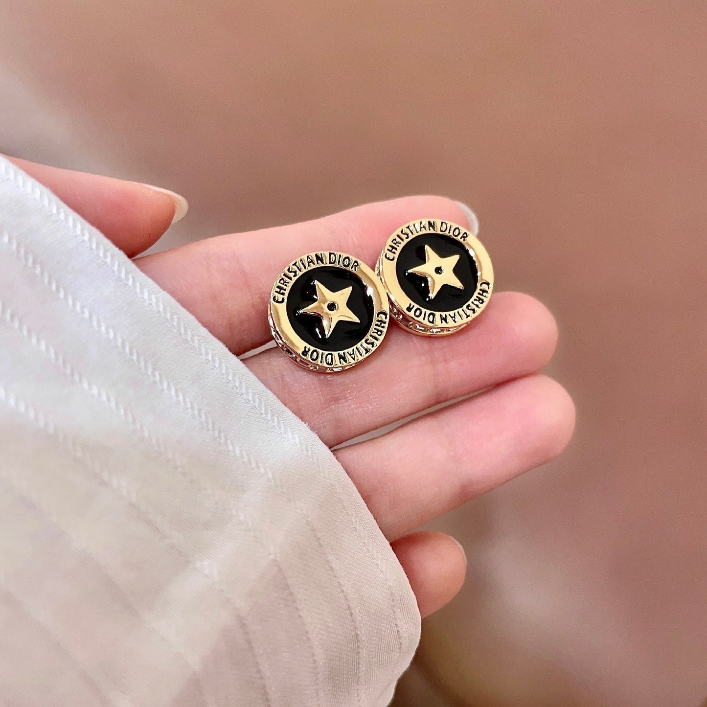 CD 26S STAR MEDALLION LOGO STUD EARRINGS IN BLACK ENAMEL & GOLD TONE METAL 631813