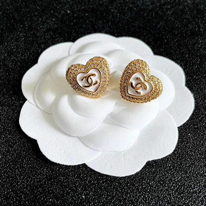 CHANEL 26S DOUBLE C LOGO PAVE HEART STUD EARRINGS WITH WHITE ENAMEL IN GOLD METAL 631815