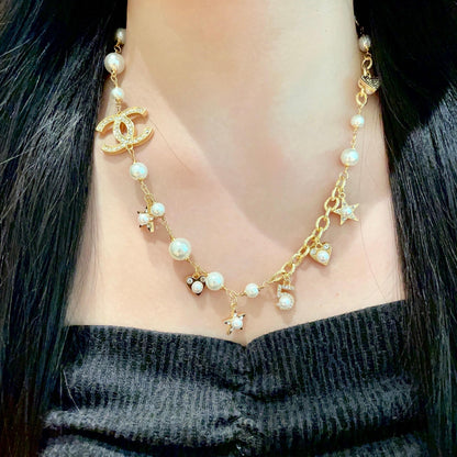 CHANEL 26S DOUBLE C LOGO PEARL CHARM NECKLACE WITH STAR AND HEART DETAILS IN GOLD METAL 631895