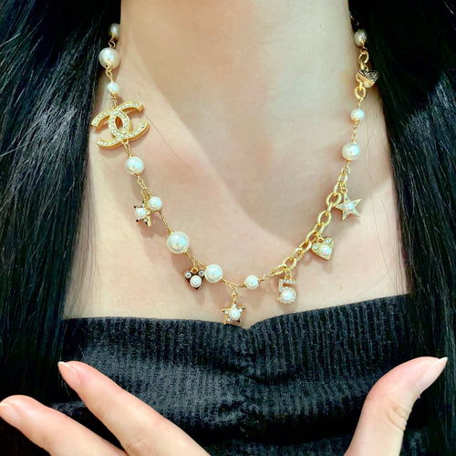 CHANEL 26S DOUBLE C LOGO PEARL CHARM NECKLACE WITH STAR AND HEART DETAILS IN GOLD METAL 631895