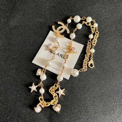 CHANEL 26S DOUBLE C LOGO PEARL CHARM NECKLACE WITH STAR AND HEART DETAILS IN GOLD METAL 631895