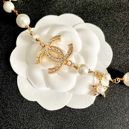 CHANEL 26S DOUBLE C LOGO PEARL CHARM NECKLACE WITH STAR AND HEART DETAILS IN GOLD METAL 631895