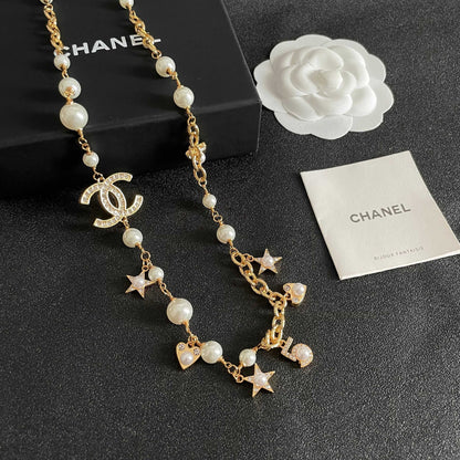 CHANEL 26S DOUBLE C LOGO PEARL CHARM NECKLACE WITH STAR AND HEART DETAILS IN GOLD METAL 631895