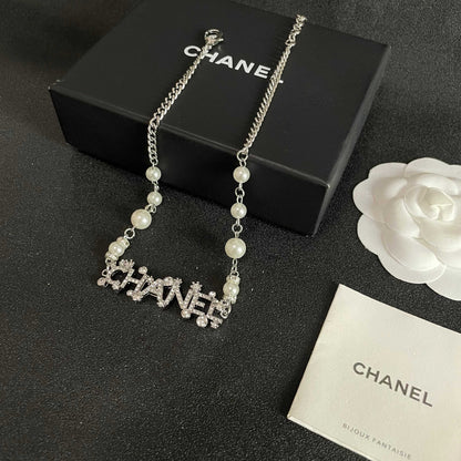 CHANEL 26S CHANEL LETTER CRYSTAL NECKLACE WITH PEARL DETAILS IN SILVER METAL 631901
