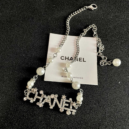 CHANEL 26S CHANEL LETTER CRYSTAL NECKLACE WITH PEARL DETAILS IN SILVER METAL 631901