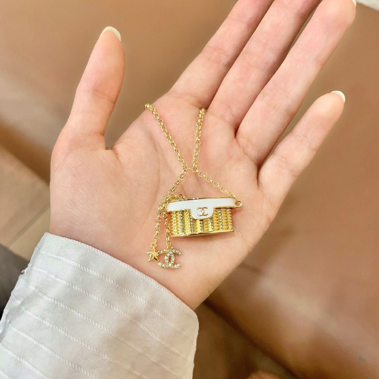 CHANEL 26S DOUBLE C LOGO MINI VANITY BAG PENDANT NECKLACE WITH STAR CHARM IN GOLD METAL 633291