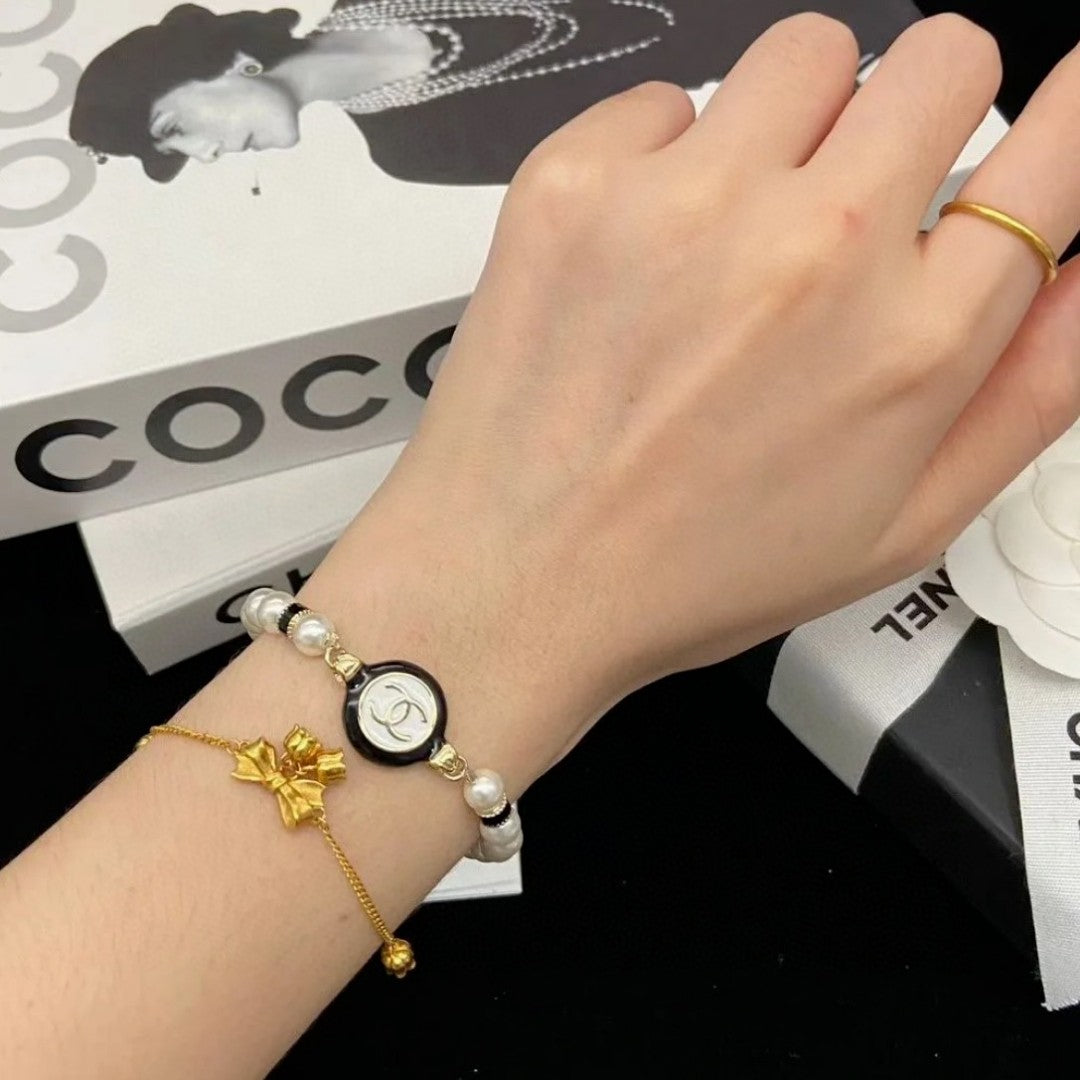 Classic CC bracelet with faux pearls and black resin.