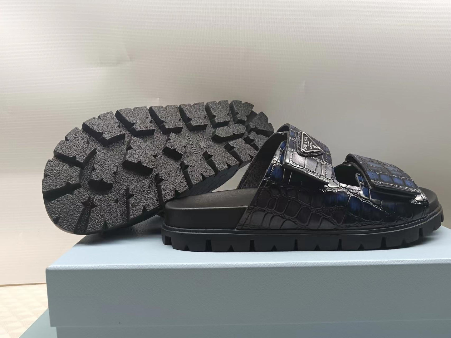 PRADA 26S STRAP SLIDES IN BLACK CROC EMBOSSED CALFSKIN