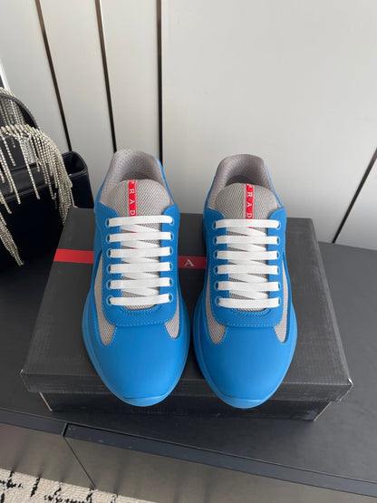 PRADA 26S AMERICA CUP SNEAKERS IN AZURE BLUE SOFT RUBBER AND BIKE FABRIC